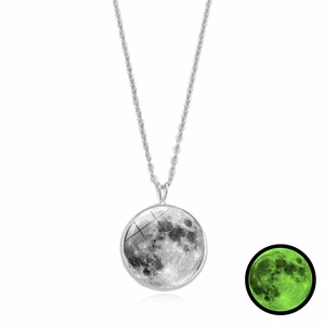 Detail showing the luminous green glow effect of the moon pendant in dark conditions