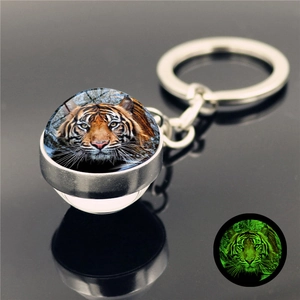 Luminous tiger head crystal glass ball keychain with silver metal ring and green glow effect