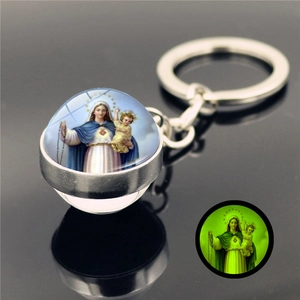 Glow-in-the-dark Virgin Mary glass ball keychain with luminous green light effect