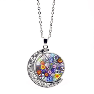 Macro detail of crescent moon pendant with colorful glass floral mosaic on silver chain