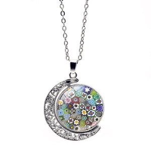 Macro view of silver moon pendant with colorful Venetian style Millefiori glass patterns