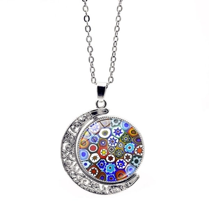 Detail of silver crescent moon pendant with colorful Italian Millefiori glass patterns