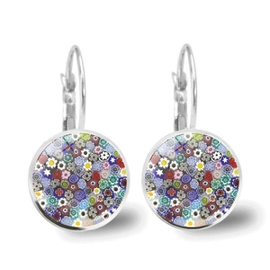 Close-up of Millefiori art glass earrings with colorful floral patterns in silver setting