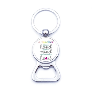 Macro detail of silver metal beer bottle opener keychain with teacher quote engraving
