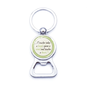 Macro view of metal bottle opener keychain with teacher appreciation quote on green dots