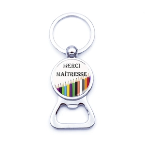 Detail of metal bottle opener keychain with Merci Maîtresse pencil design for teachers
