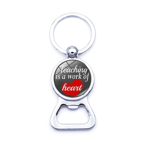 Silver beer bottle opener keychain with Teaching is a work of heart slogan for teachers