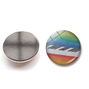 Detailansicht eines runden Glasmagnets mit Klaviertasten und magnetischer Rückseite
