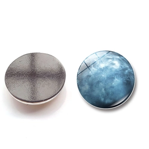 Detail of galaxy planet glass fridge magnet showing the dome top and magnetic base