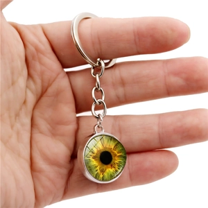 Handheld evil eye keychain featuring a double-sided crystal glass ball with green iris iris