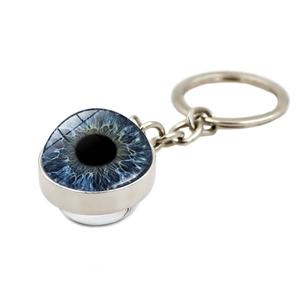 Detailed close-up of a glass evil eye keychain with blue iris and silver metal ring