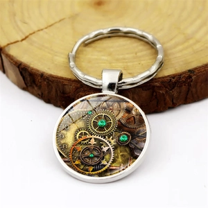 Detailed close-up of steampunk gear keychain on a rustic wood slice background