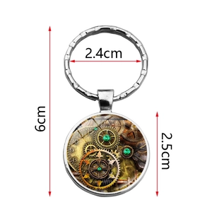 Close-up of steampunk gear pendant keychain with size dimensions in silver finish