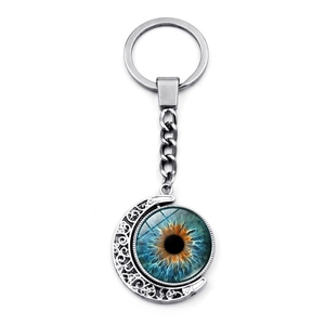 Detail of blue and orange evil eye glass moon pendant with silver metal keychain