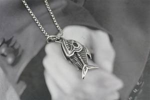 Détail macro du pendentif squelette de poisson en acier avec finition vintage noire