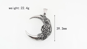 Detailed view of crescent moon pendant with rose engraving in retro steel finish