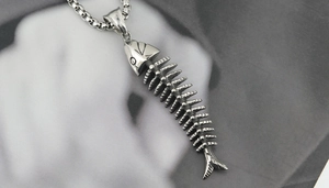 Detailed close-up of a vintage silver stainless steel fish skeleton pendant necklace