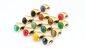Detailed macro view of Taoist Tai Chi rings with various colorful gemstone inlays