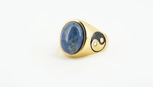Macro shot of a gold signet ring featuring lapis lazuli and yin-yang side accents