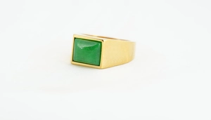 Detailaufnahme eines Herrenrings aus Gold mit rechteckigem grünen Edelstein-Inlay