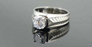 Macro side view of men's titanium ring with round cubic zirconia and textured band