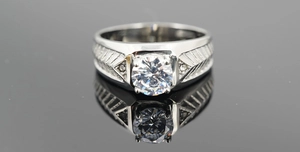 Macro detail of men's titanium ring with large round stone and side diamond accents