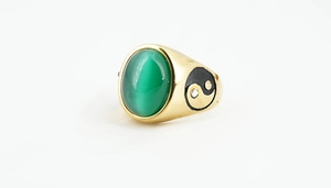 Detail of 18K gold vintage ring featuring green cat eye stone and yin yang engraving