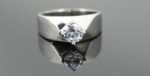 Macro shot of men's silver titanium steel ring with a four-prong set round cubic zirconia stone