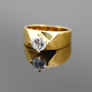 Classic gold titanium steel ring featuring a large round diamond and geometric faceted band