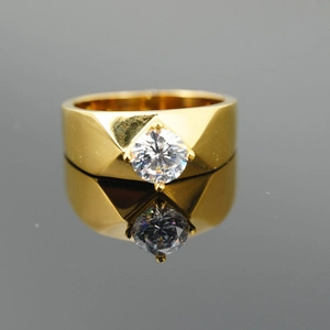 Classic gold titanium steel ring featuring a brilliant round-cut center stone on dark mirror