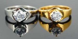 Detail of silver and gold plated signet rings with hexagonal set cubic zirconia stones