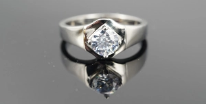 Macro detail of silver titanium steel ring featuring a hexagonal solitaire zircon setting