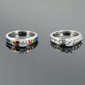Titanium steel couple rings featuring rainbow baguette stones and a classic white diamond