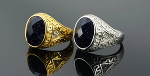 Macro detail of vintage steel signet rings with blue sandstone and Greek fret patterns