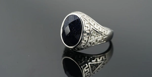 Detail of blue sandstone men's ring featuring Greek meander patterns and silver finish