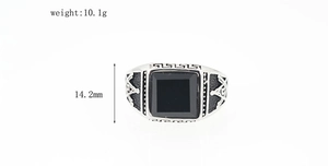 Macro detail of silver Masonic stainless steel ring with black stone inlay and side engraving