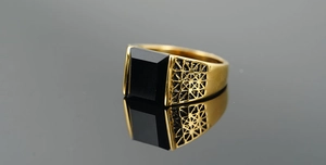 Macro shot of gold vintage men's ring with large rectangular black stone inlay