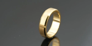 Detailed view of golden beveled edge ring with brushed metal texture and polished interior