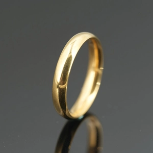 Polished gold minimalist stainless steel band ring with a reflective mirror finish