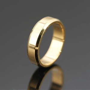 Polished gold titanium steel ring with beveled edges shown with elegant reflection