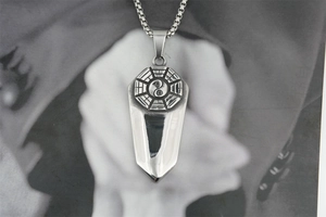 Detail of vintage Tai Chi Bagua sword pendant necklace in silver stainless steel finish