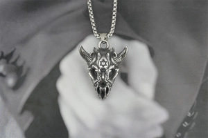 Macro detail of gothic goat skull pendant with hexagram engraving and silver steel chain