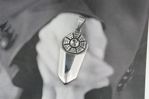 Detailed view of vintage Tai Chi sword pendant in polished silver stainless steel