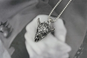 Close-up of vintage titanium steel skull pendant with hexagram star and box chain