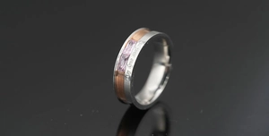 Detail of two-tone steel ring with pink stones and I am your only love engraving