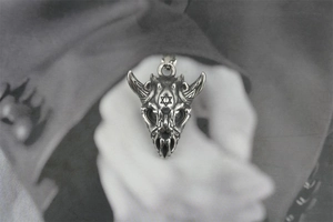 Close-up of vintage steel ram skull pendant with engraved hexagram star detail