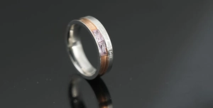 Detailed close-up of dual-tone ring with purple stones and sentimental engraving