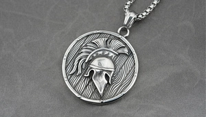 Macro detail of Spartan helmet pendant with vintage oxidized steel finish on box chain