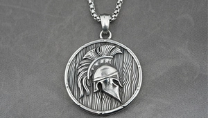 Close-up of Spartan helmet relief pendant with wood grain texture and square link chain