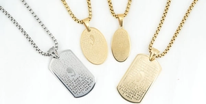 Detail of silver and gold religious dog-tag pendants with square link chain necklaces